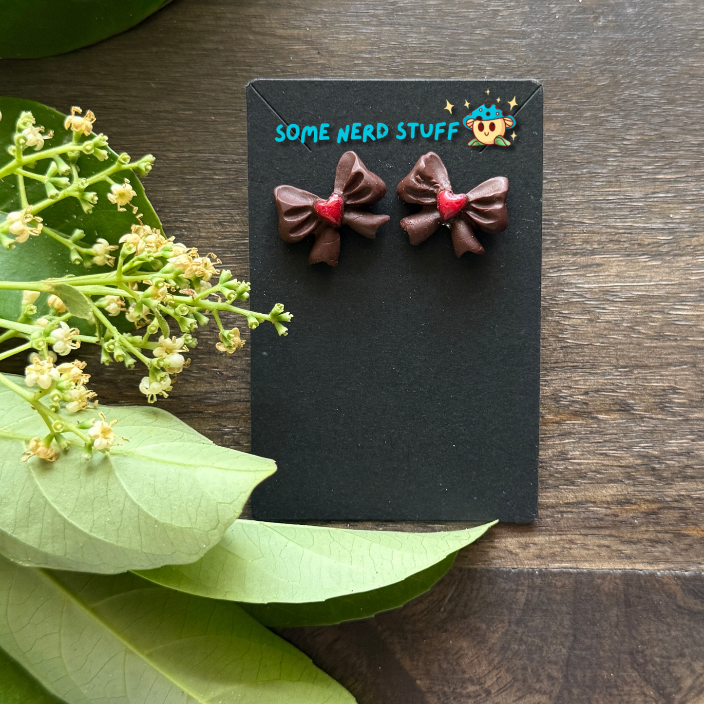 Chocolate bows with red heart center polymer clay handmade earrings by SomeNerdStuff