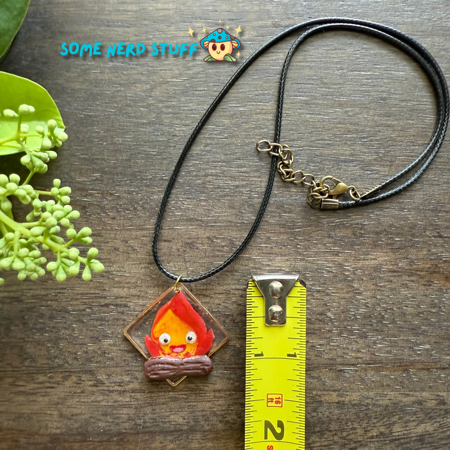 Calicifer Polymer Clay and Resin charm hung from necklace made by SomeNerdStuff