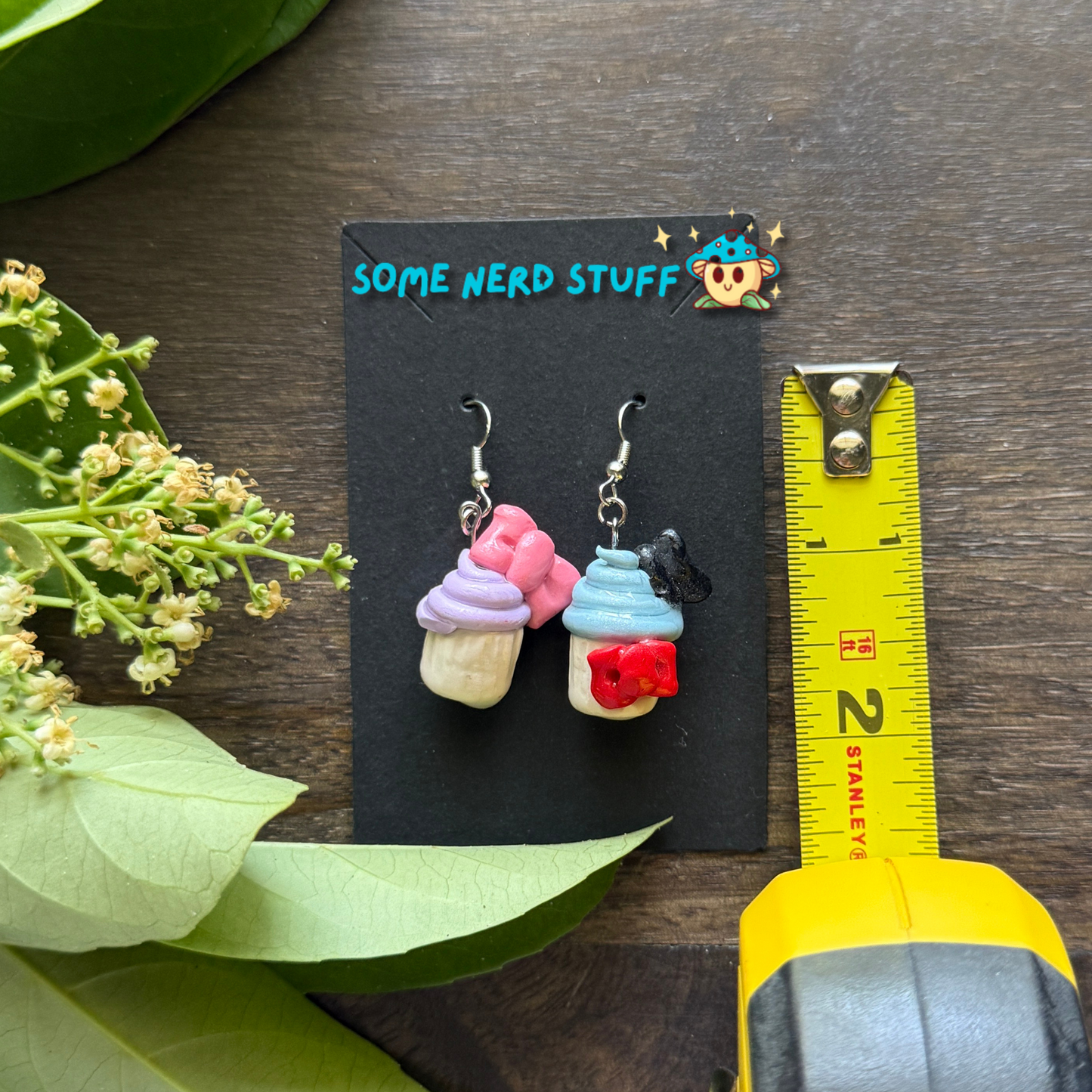 Donald and Daisy Duck Cupcake Earrings made with Polymer Clay shown with measuring tape by SomeNerdStuff