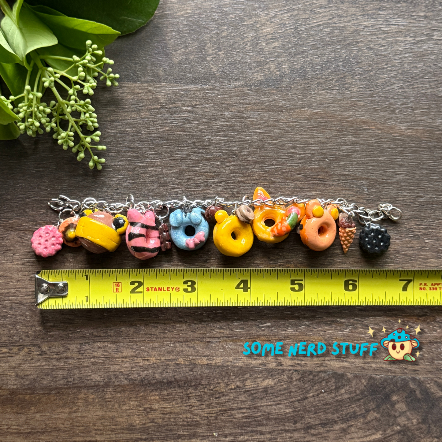 Disney Winnie the Pooh polymer Clay inspired bracelet with mini desserts and character charms shown with measuring tape made by SomeNerdStuff