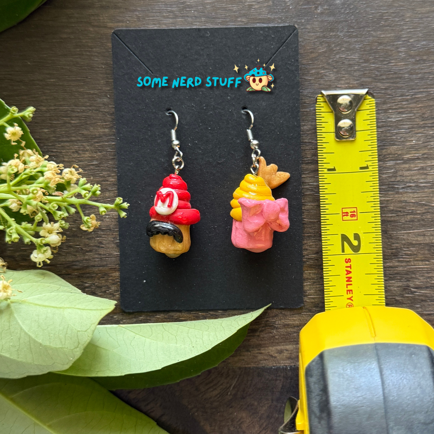 Mario and Peach Cupcake Polymer Clay earrings shown with measuring tape made by SomeNerdStuff