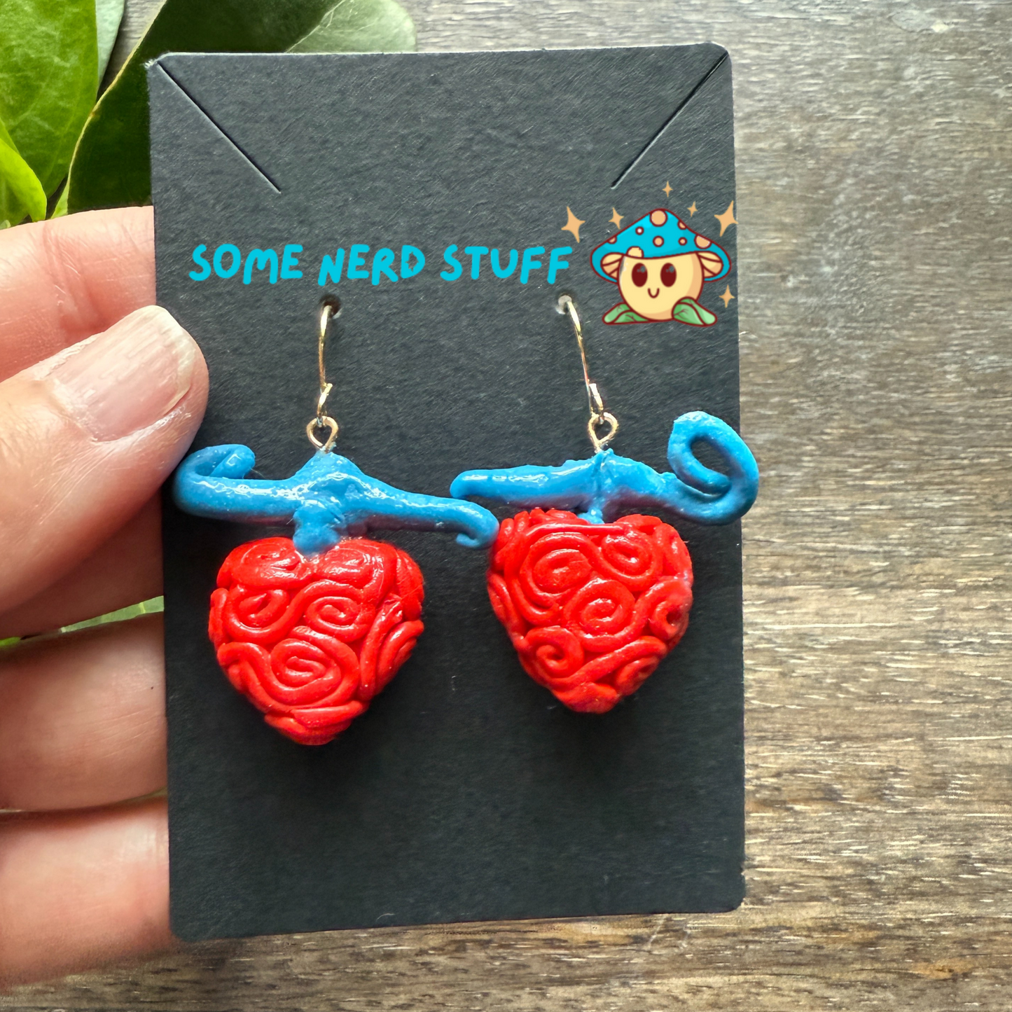 Ope Ope no Mi Devil Fruit One Piece Earrings SomeNerdStuff show in hand for size
