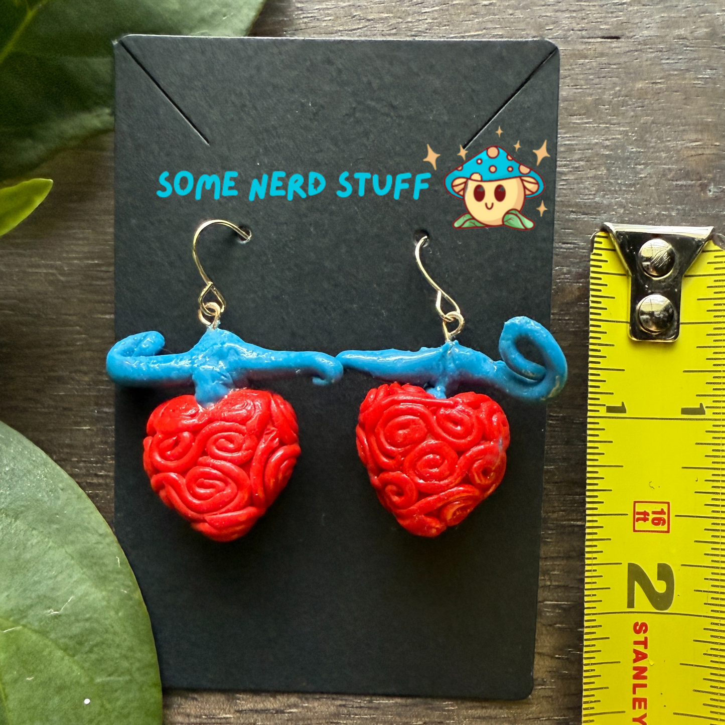 Ope Ope no Mi Devil Fruit One Piece Earrings SomeNerdStuff shown with measuring tape