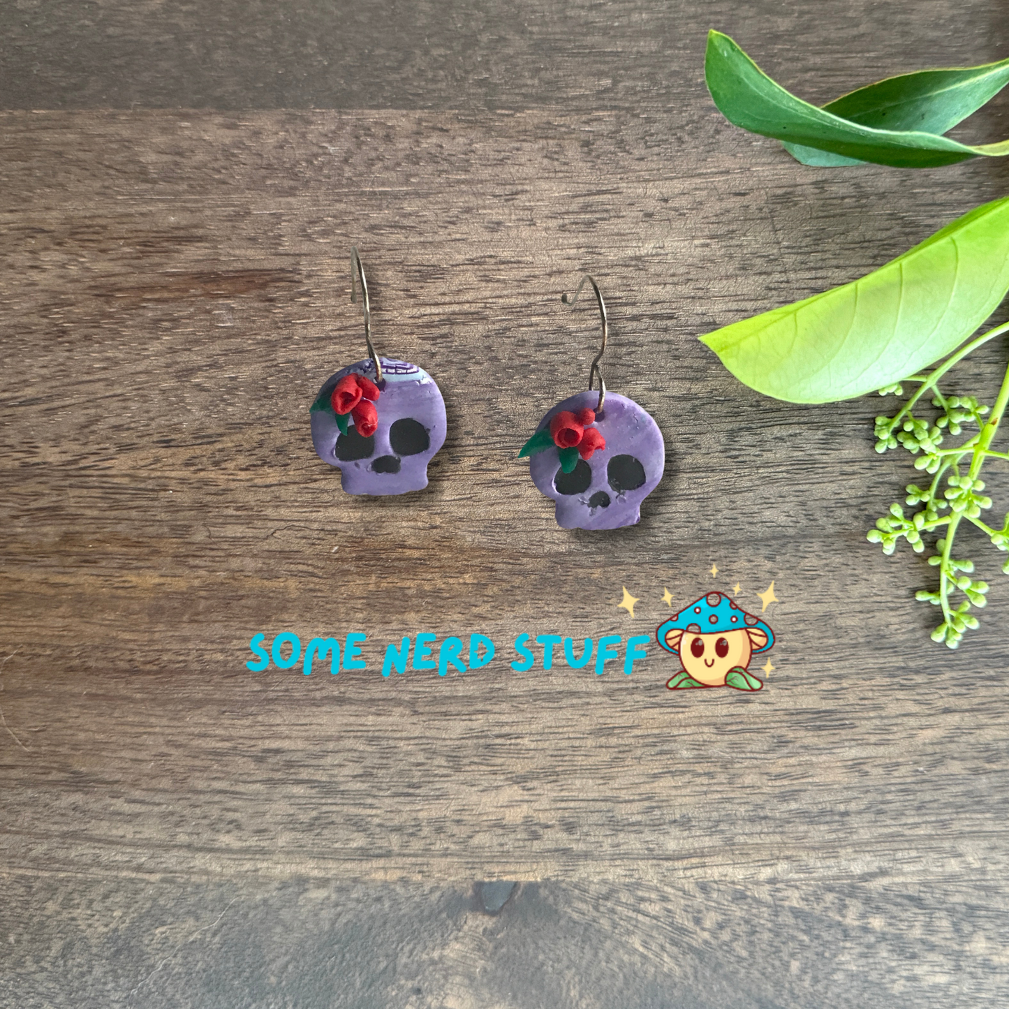 Purple Polymer Clay skulls decorated with red roses made by SomeNerdStuff
