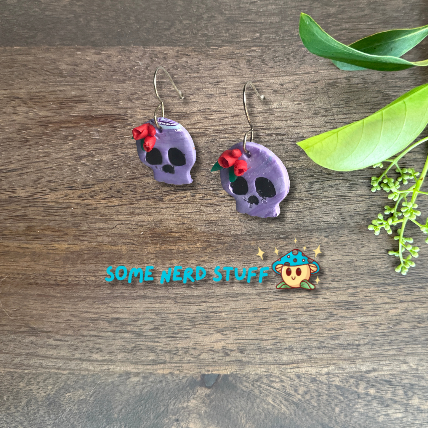 Purple Polymer Clay skulls decorated with red roses made by SomeNerdStuff