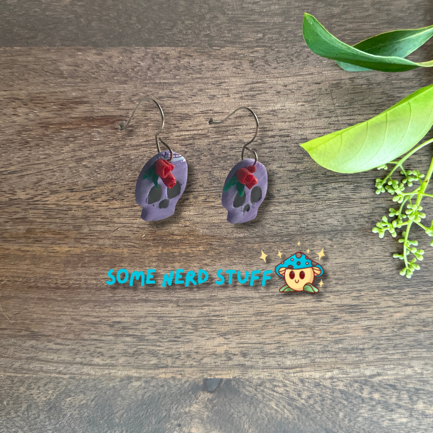 Purple Polymer Clay skulls decorated with red roses made by SomeNerdStuff