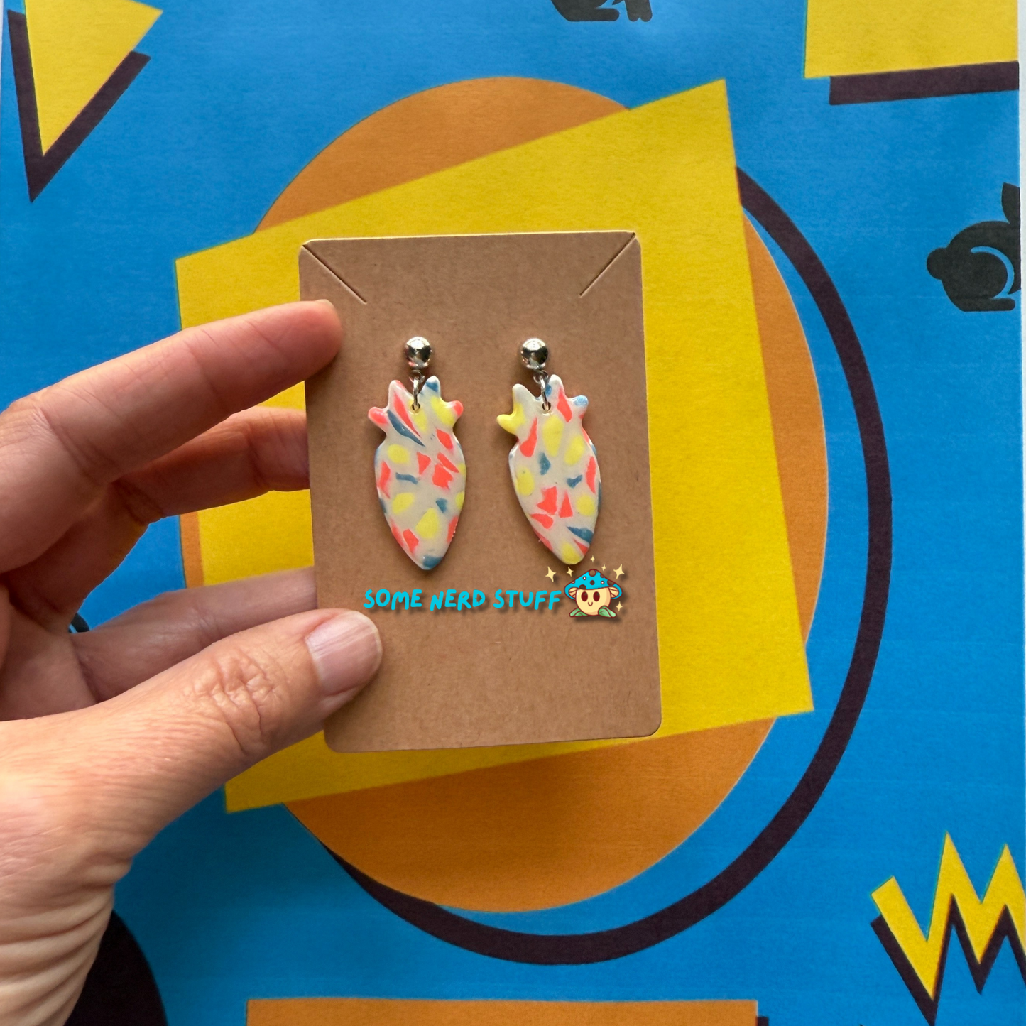 Carrot Silhouette Polymer Clay Earrings inspired by Saved by the Bell 90s show multicolor held with hand to show size made by SomenerdStuff