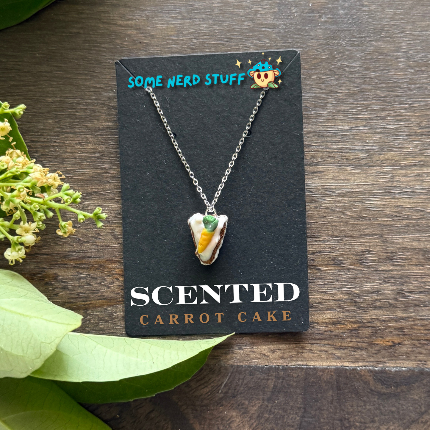Scented polymer clay carrot cake charm and necklace side of cake view made by SomeNerdStuff