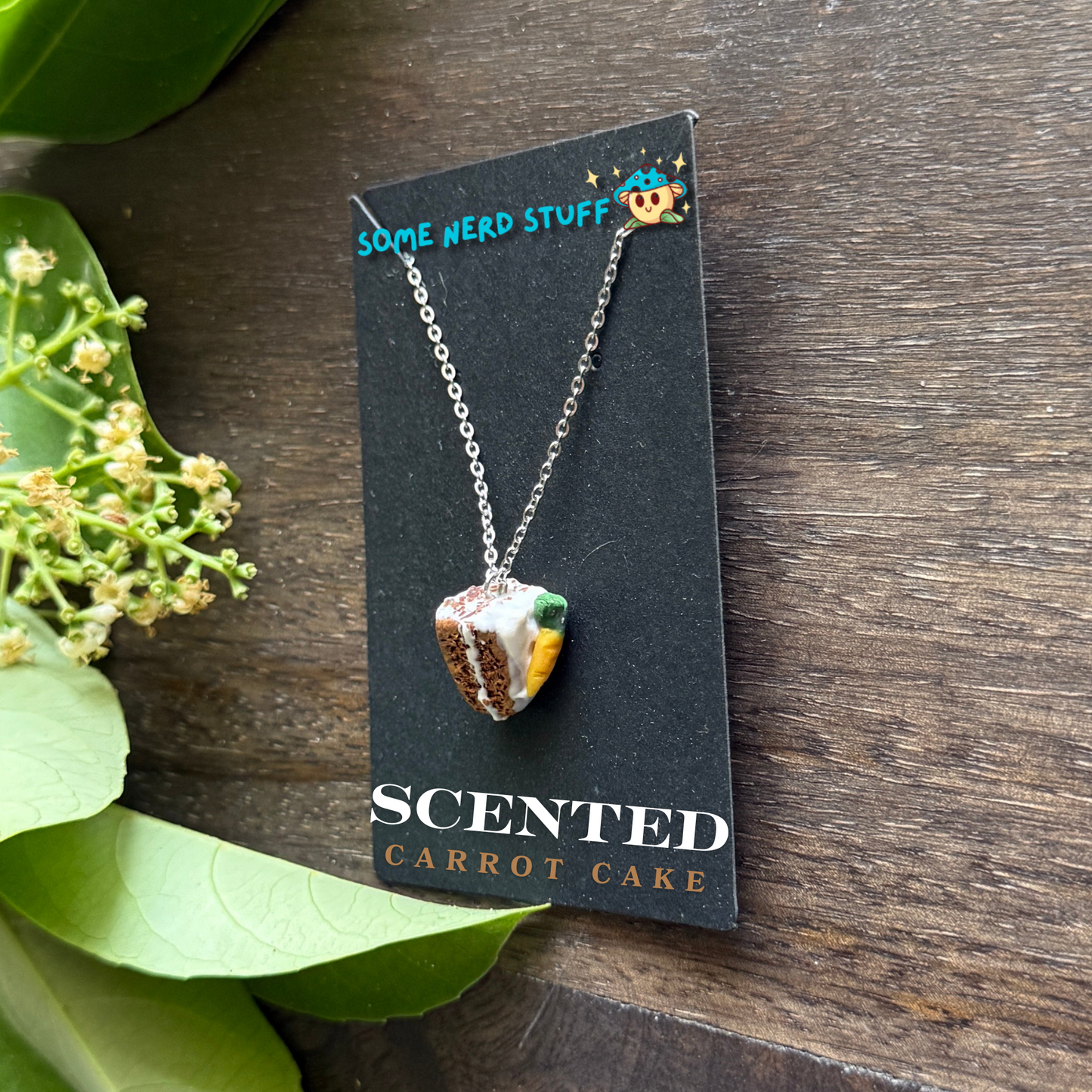 Scented polymer clay carrot cake charm and necklace side of cake view made by SomeNerdStuff
