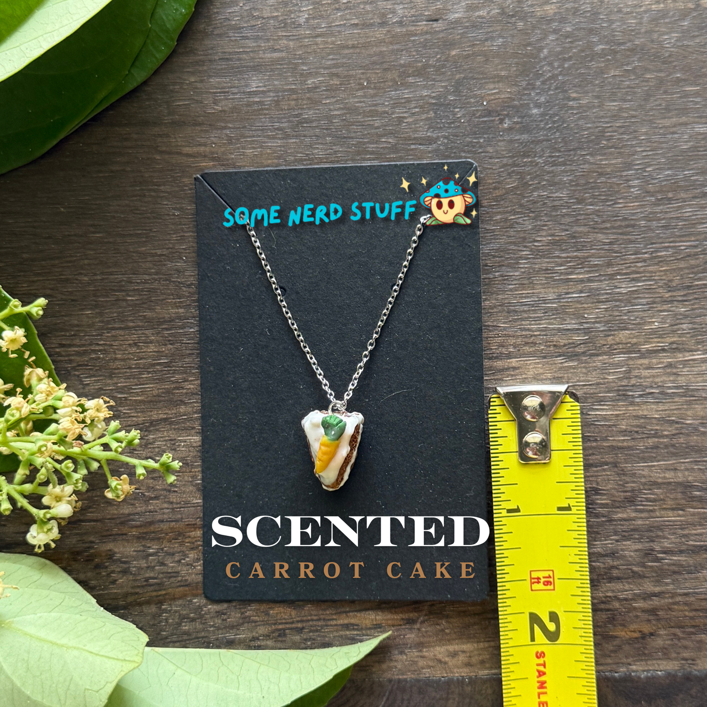 Scented polymer clay carrot cake charm and necklace side of cake view made by SomeNerdStuff