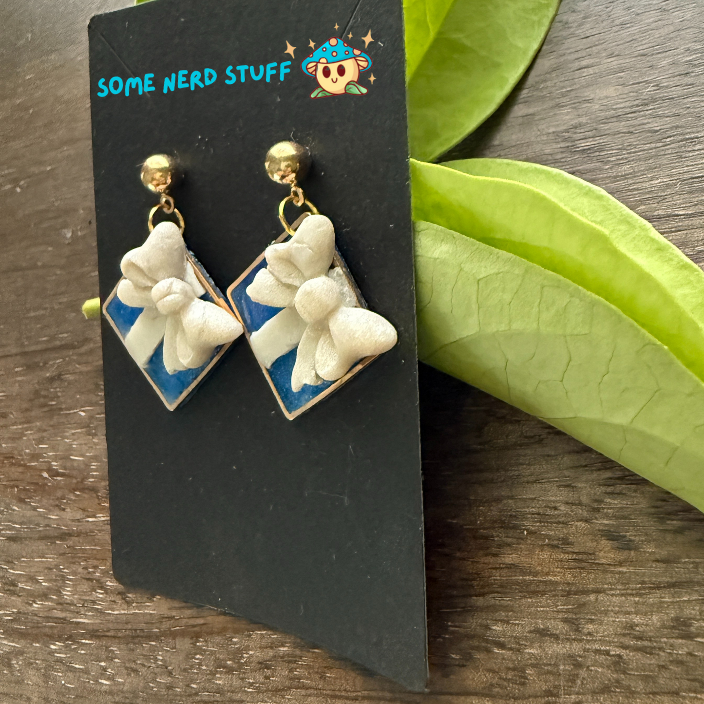 Tiffany's jewlery inspired polymer clay bow earrings, shown side view.