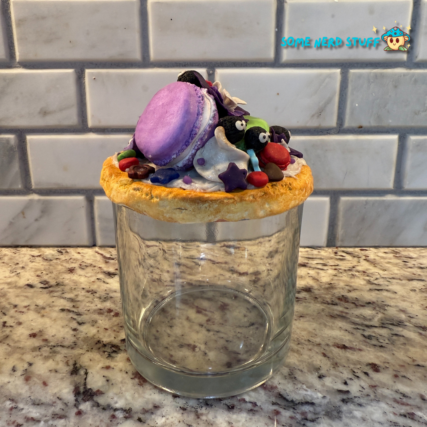 Soot Sprite Stash Jar topped with polymer clay macarooms, Soot Sprites, chocolate pieces, orchids Side of jar