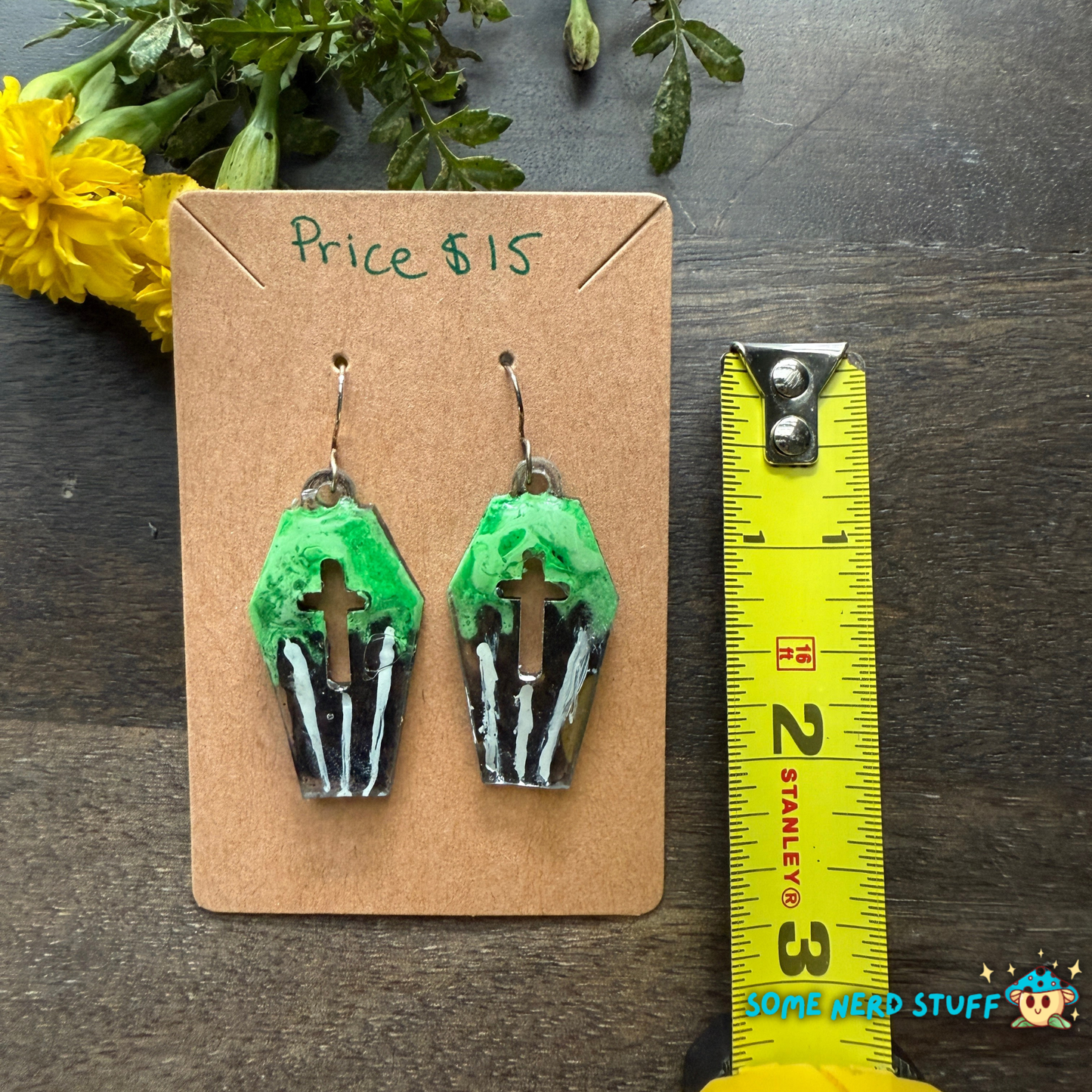 Coffin shapped earrings with green and striped pattern hand made earrings by somenerdstuff with a measuring tape