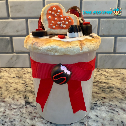 Stash Jar or Cookie Jar that is made of polymer clay over a glass jar. Decorated with clay macarons, chocolates, and dripping in chocolate glaze. Made by SomeNerdStuff.