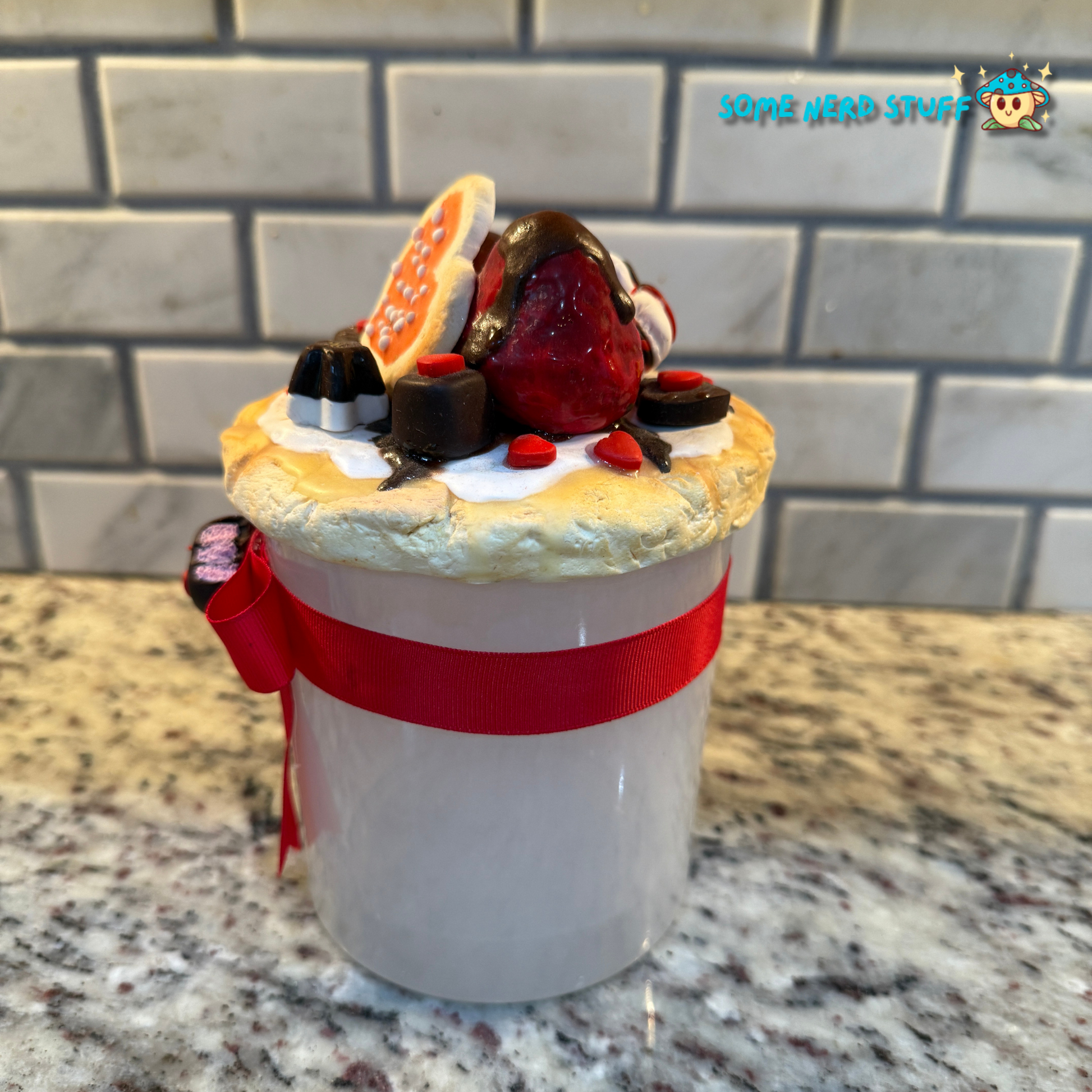 Stash Jar or Cookie Jar that is made of polymer clay over a glass jar. Decorated with clay macarons, chocolates, and dripping in chocolate glaze side of jar. Made by SomeNerdStuff.