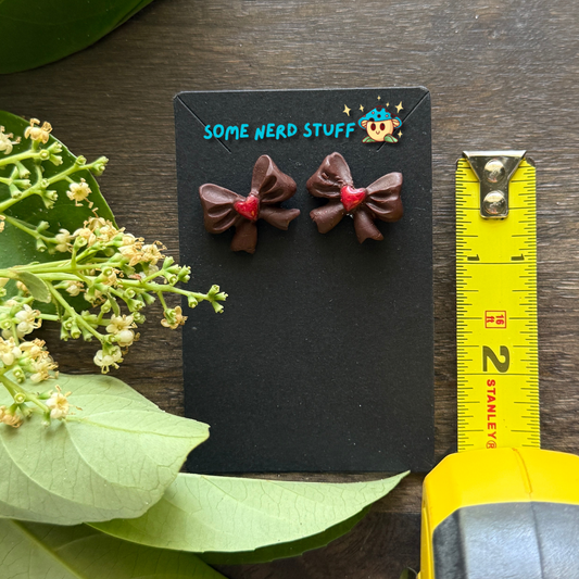 Chocolate bows with red heart center polymer clay handmade earrings by SomeNerdStuff