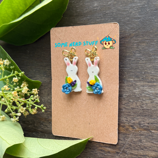 Bunny Polymer clay earrings with petite blue and yellow flwoers topped with a bow post side post