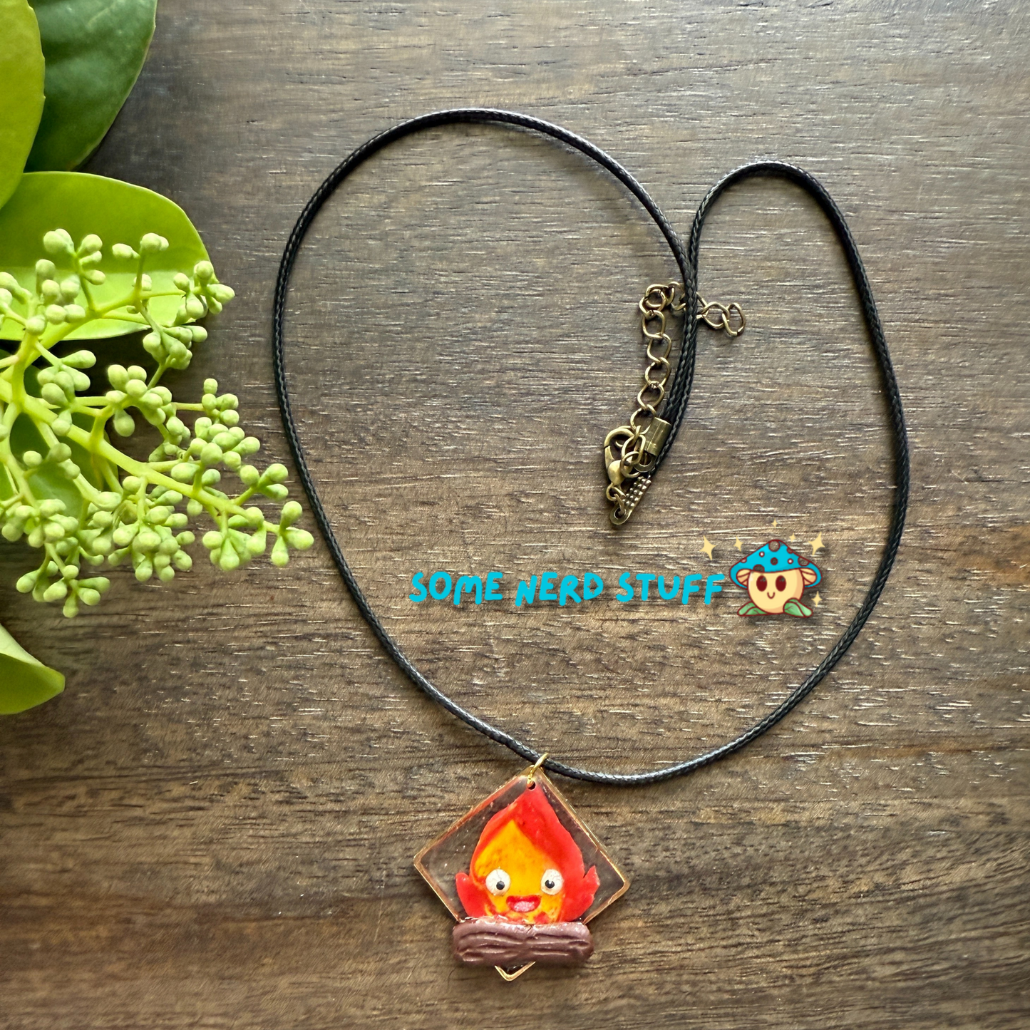 Calicifer Polymer Clay and Resin charm hung from necklace made by SomeNerdStuff