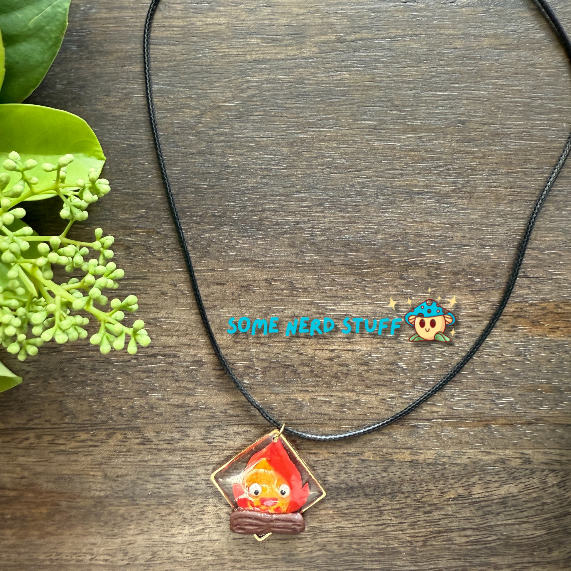 Calicifer Polymer Clay and Resin charm hung from necklace made by SomeNerdStuff