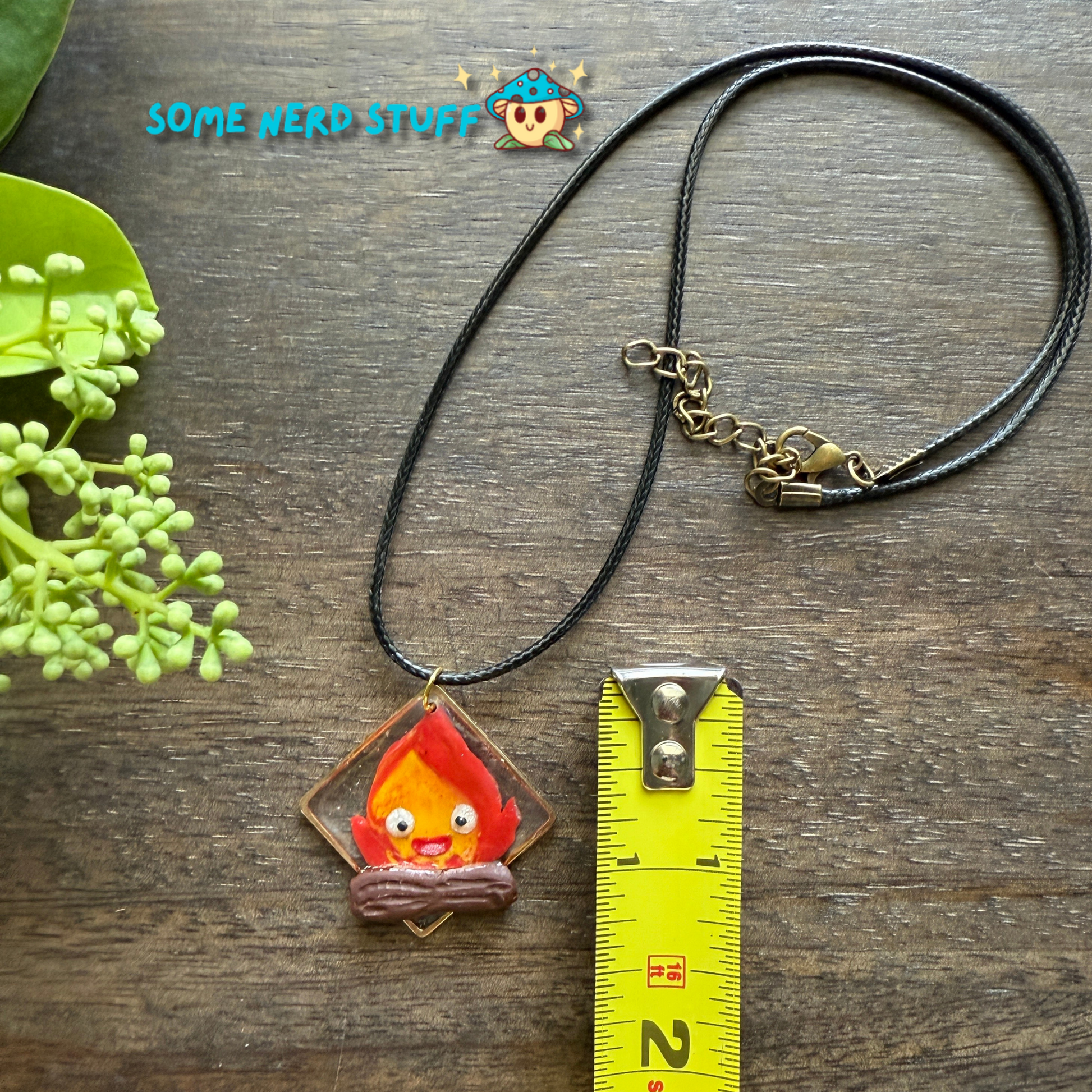 Calicifer Polymer Clay and Resin charm hung from necklace made by SomeNerdStuff