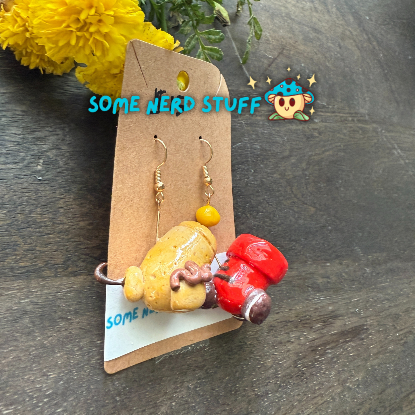 Cookie and candy cannon earrings that are bursting with color, and one candy cannon ball sold on SomeNerdStuff.com