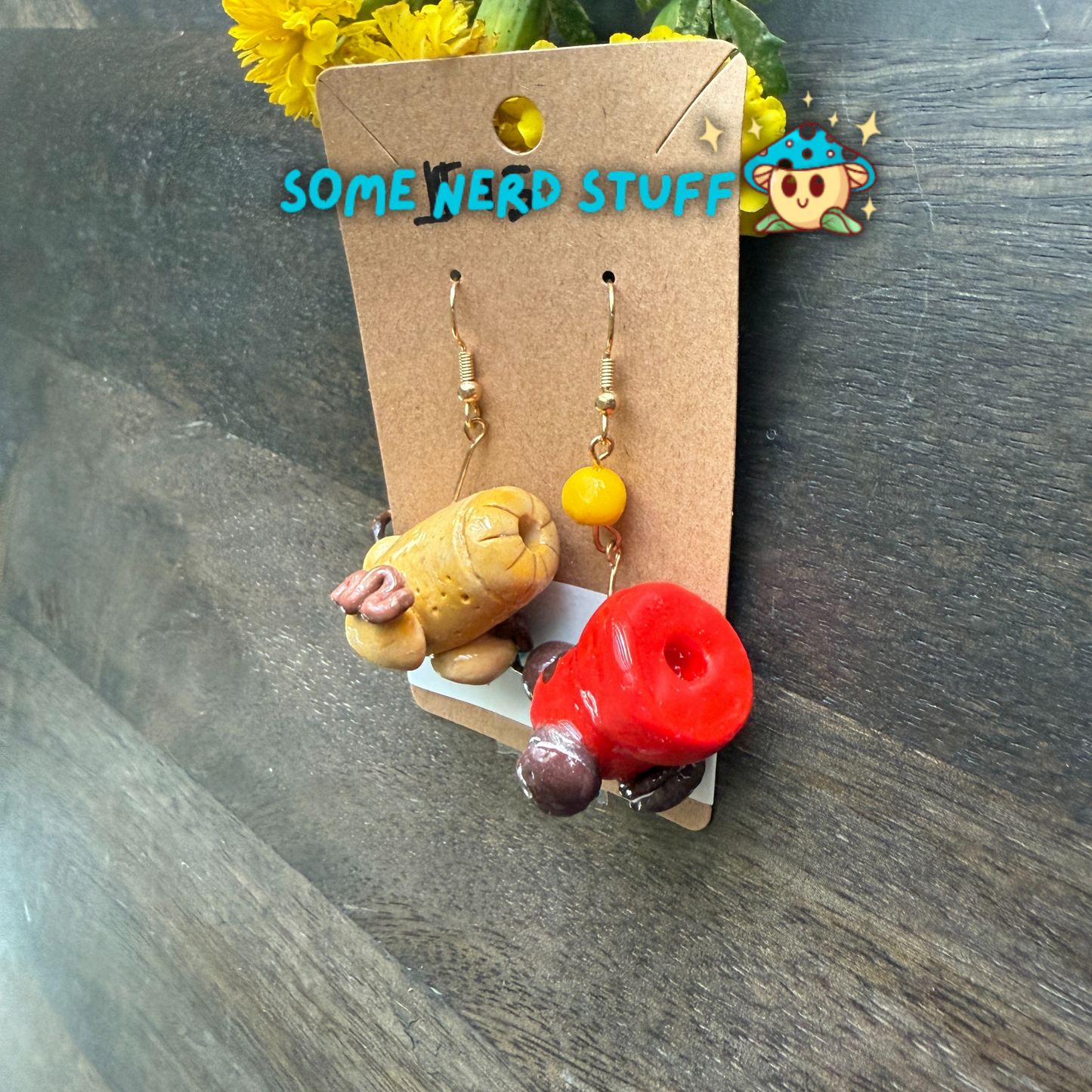 Cookie and candy cannon earrings that are bursting with color, and one candy cannon ball sold on SomeNerdStuff.com