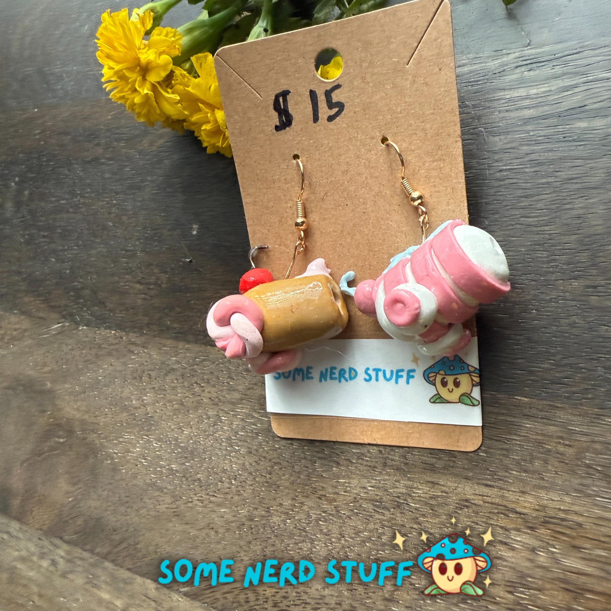 Pair of Candy Cannons Cherry topped and pepermin swirl polymer clay dangles from SomeNerdStuff side view