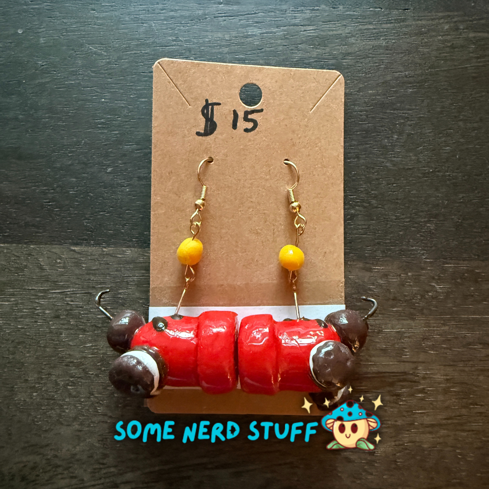 Red candy cannon and oreo cookie polymer clay earrings with cannon ball cady dangle sold on SomeNerdStuff