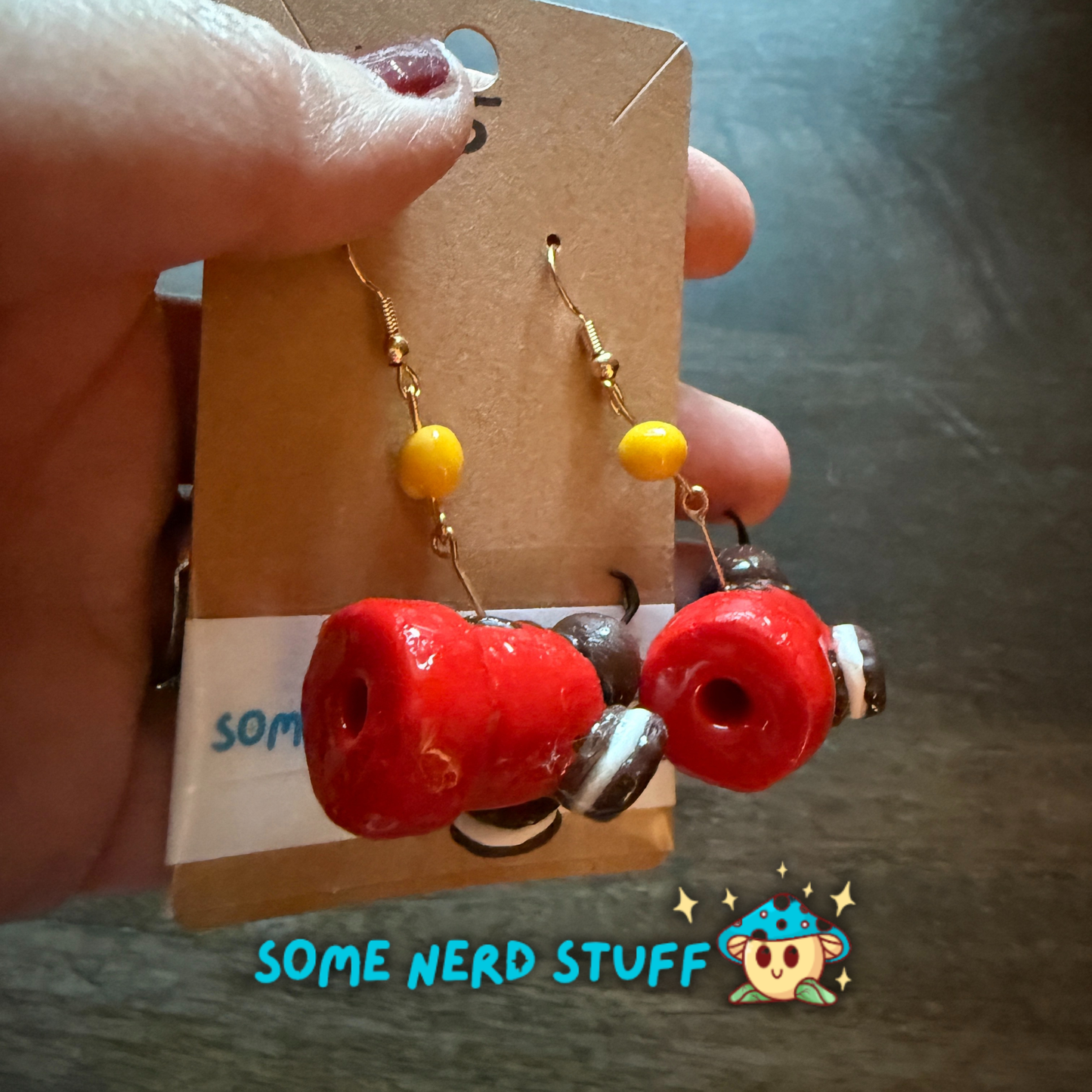 Red candy cannon and oreo cookie polymer clay earrings with cannon ball cady dangle sold on SomeNerdStuff