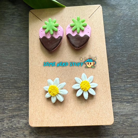 Pair of strawberry-shaped earrings on a 'Some Nerd Stuff' branded card.