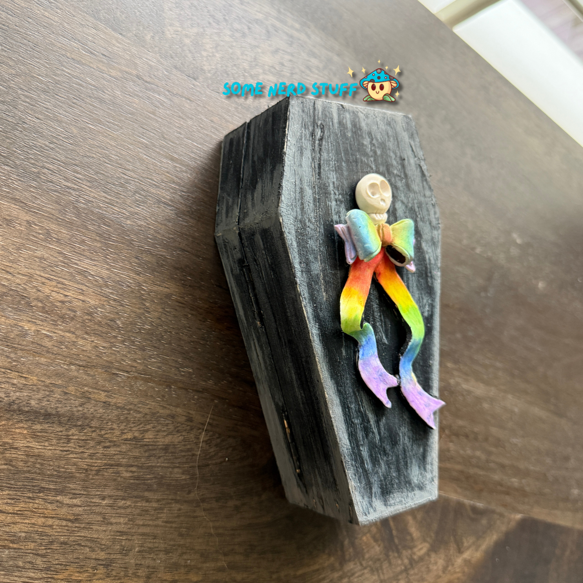 Wooden craft coffin decorated with  polymer clay ghost topped with a patchwork witch hat, mini pumpkins, tombstone, bats over the moon, and so much more.