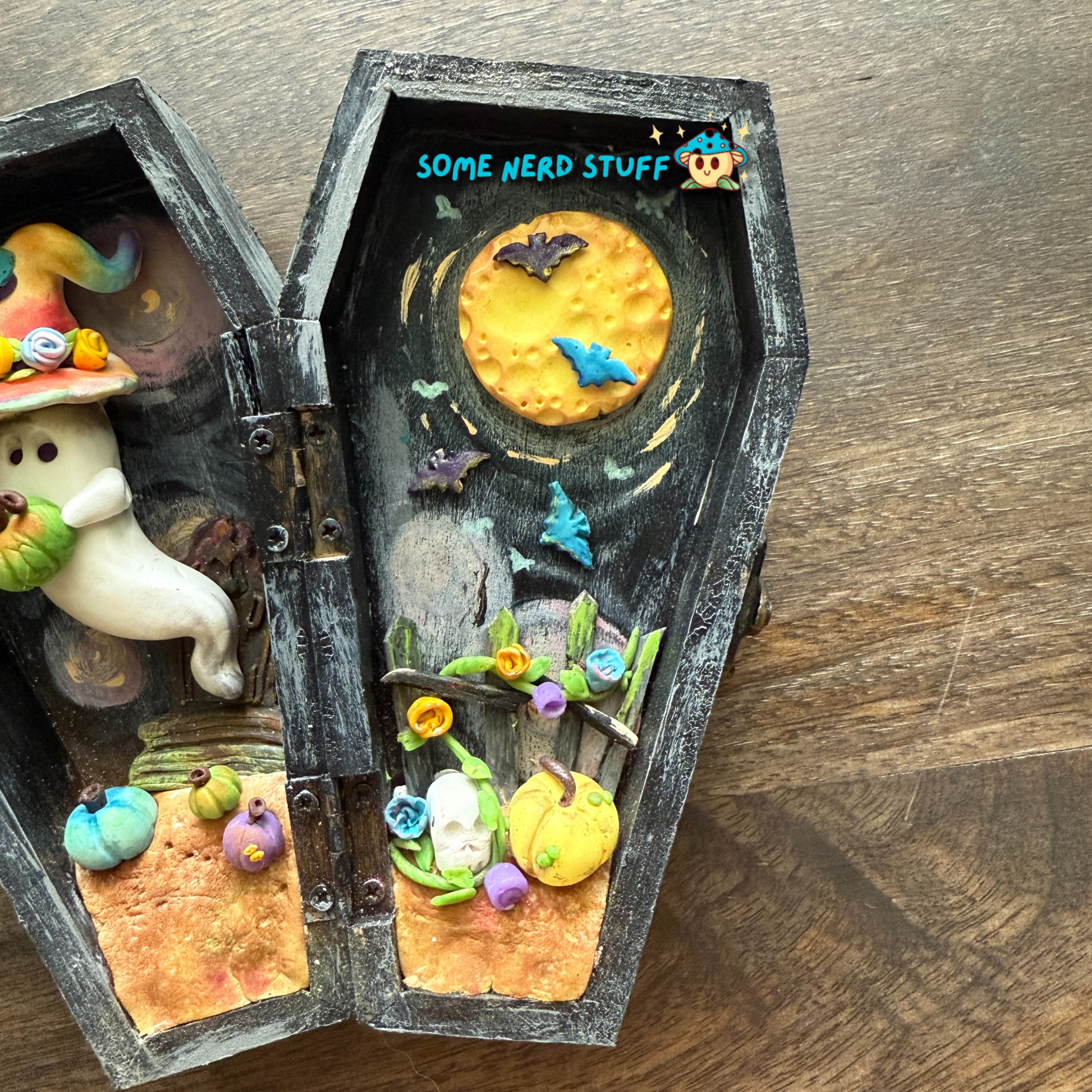 Wooden craft coffin decorated with  polymer clay ghost topped with a patchwork witch hat, mini pumpkins, tombstone, bats over the moon, and so much more Right side of coffin