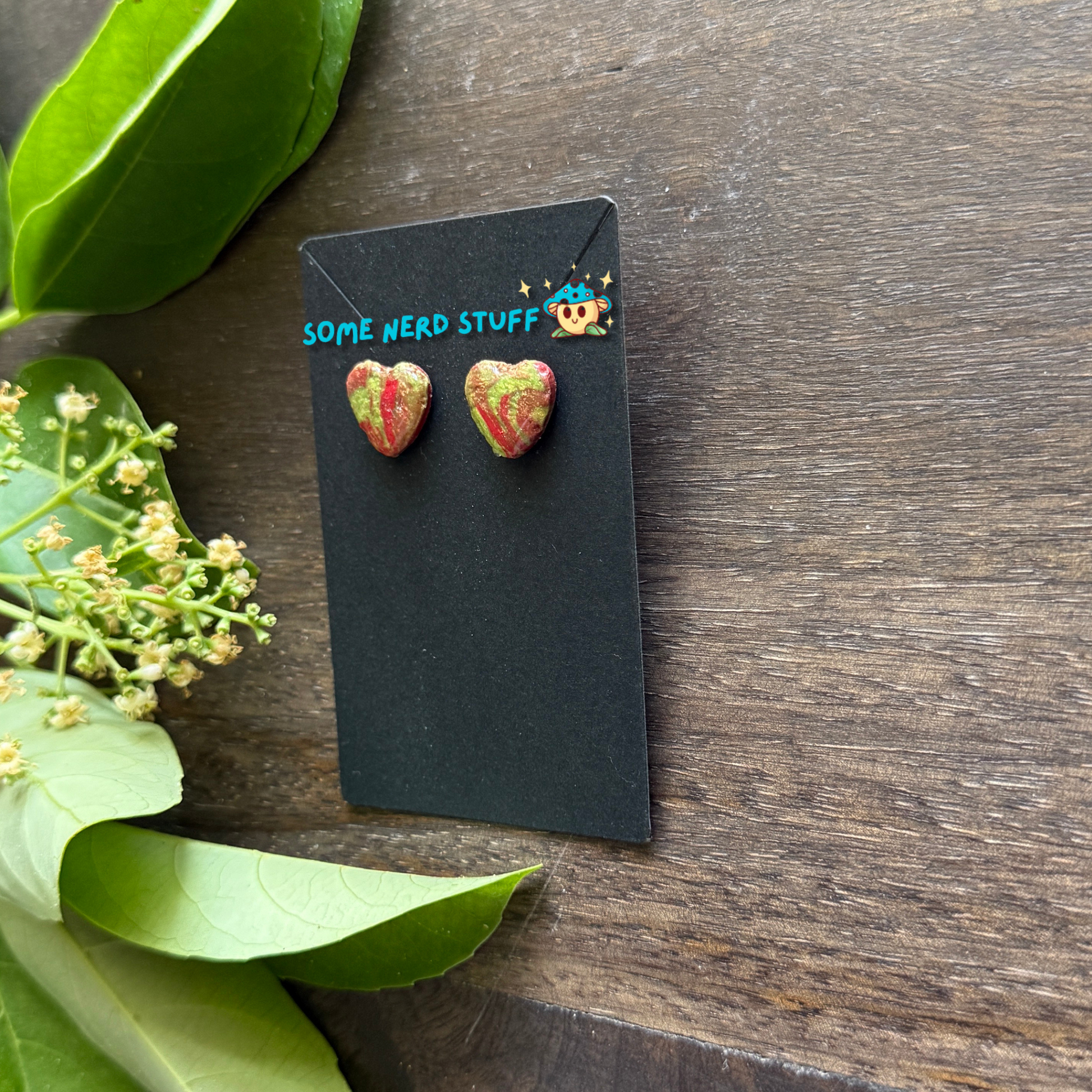 Polymer Clay swirl red and green heart earrings side view by SomeNerdStuff