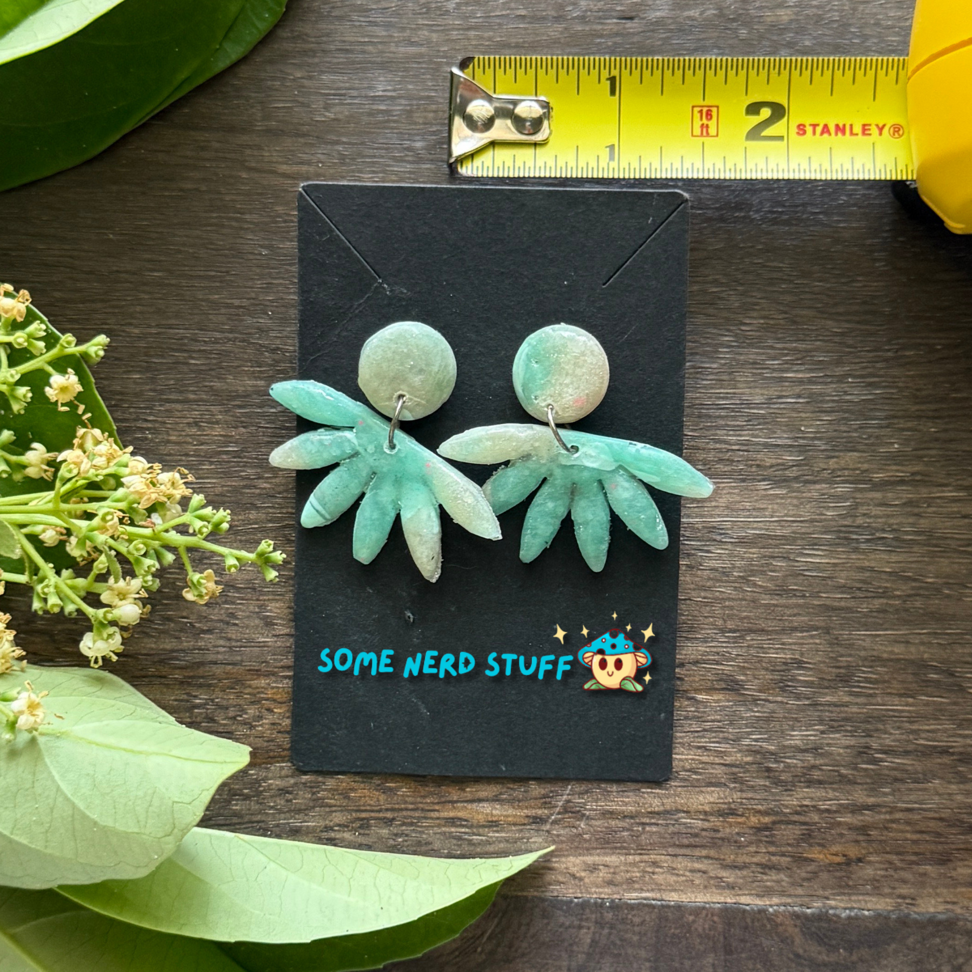 Faux polymer clay earrings with circle and horizon stone with measuring tape to show earring size