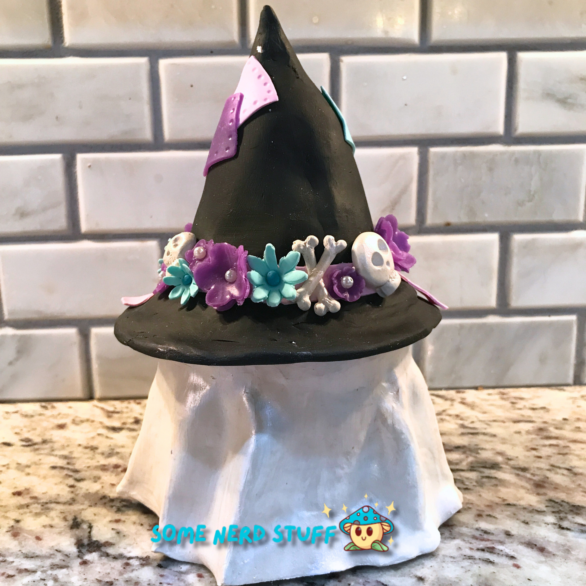 Ghost stash jar, that has a witch hat that brings to life patches, ribbon, flowers, cute skulls, and showing back of clay witch hat.