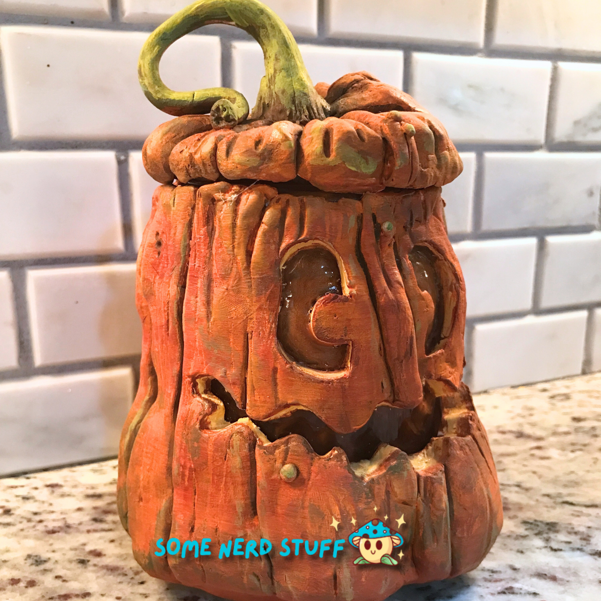 Pumpkin trinket or stash jar made out of polymer clay side view of product.