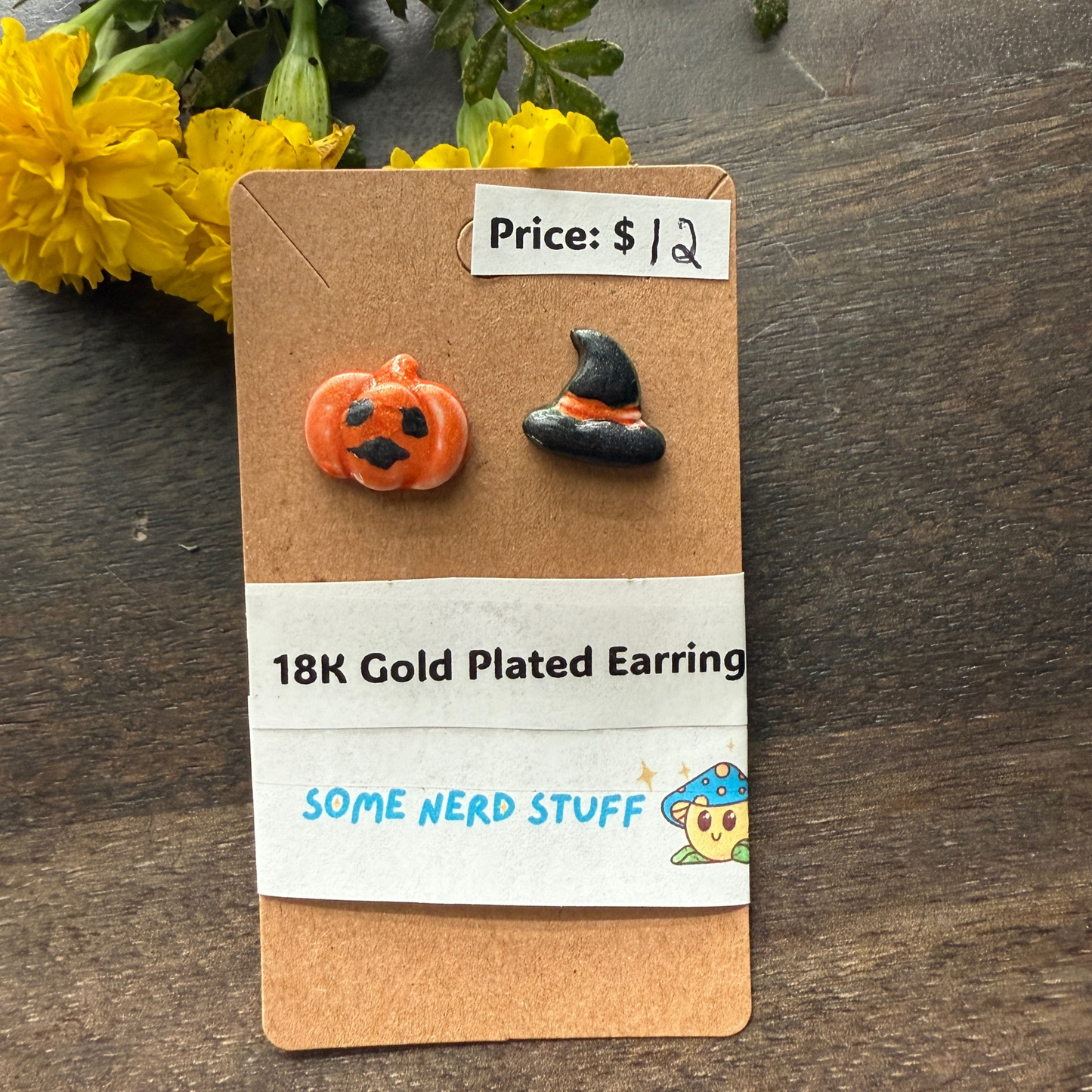 Pumpkin and black hat polymer clay hand made earrings that are 18k plated sold at somenerdstuff