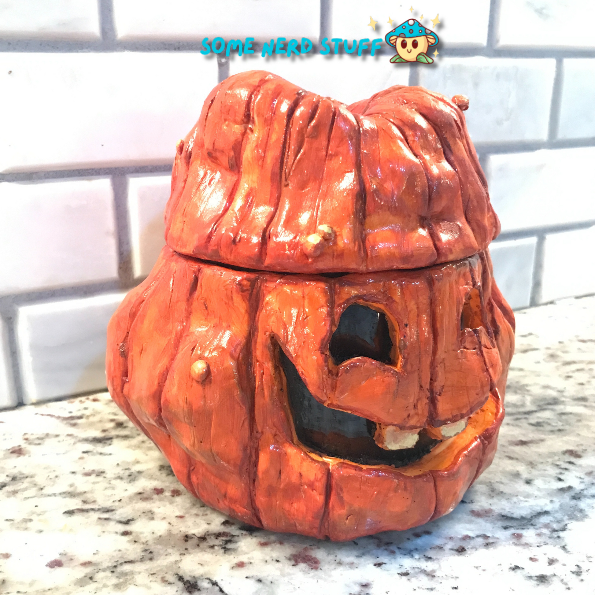 Polymer Clay pumpkin stash jar with lid and facing smiling Jolly Jack side view made by SomeNerdStuff