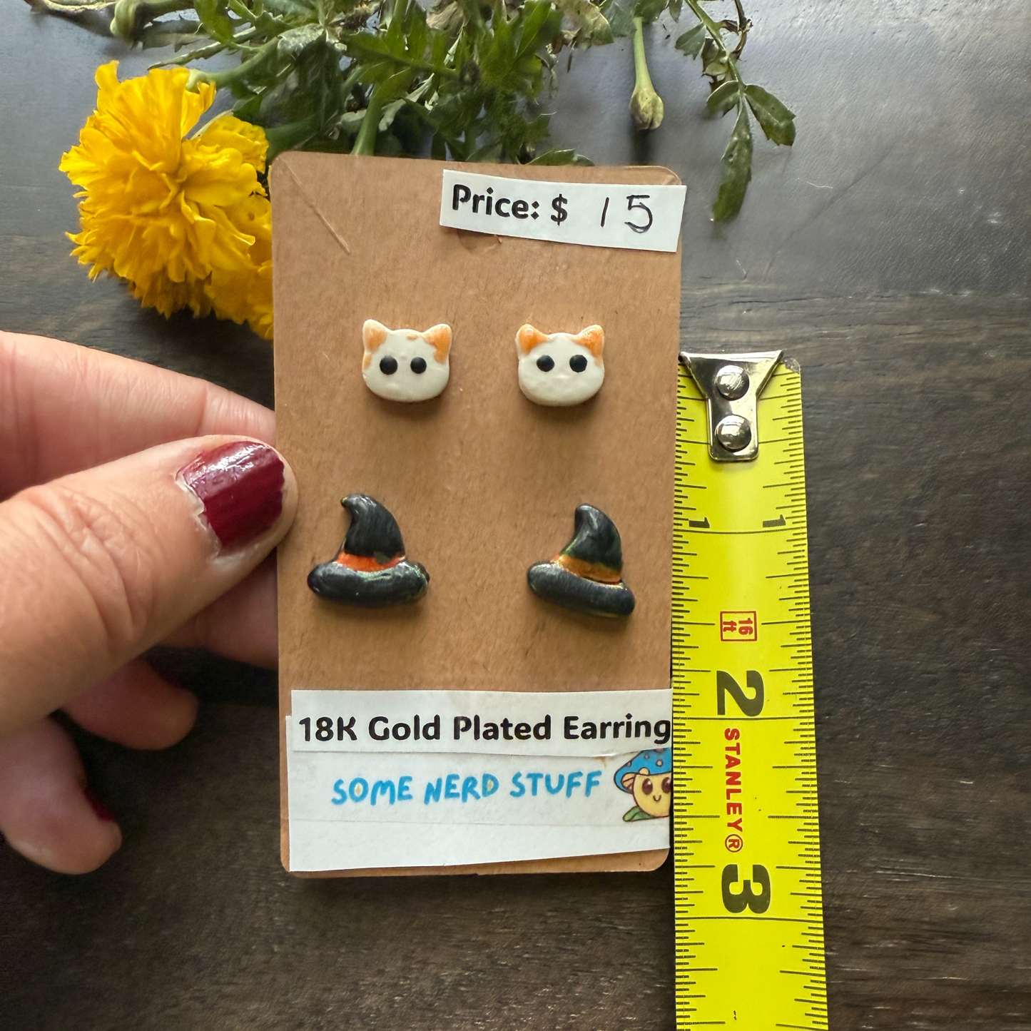 Halloween Cat and Witch hat studs that are 18k plated sold by SomeNerdStuff