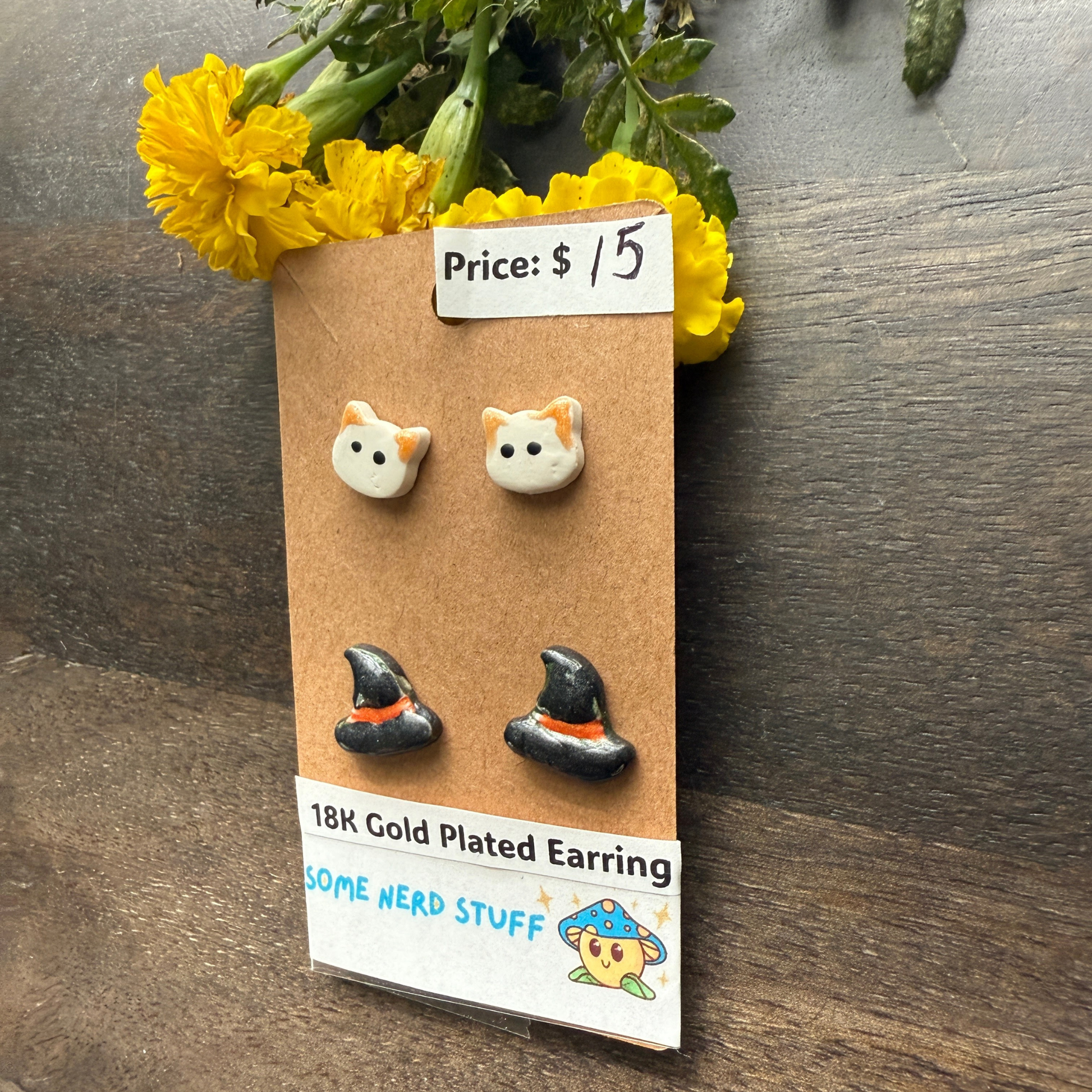 Halloween Cat and Witch hat studs that are 18k plated sold by SomeNerdStuff