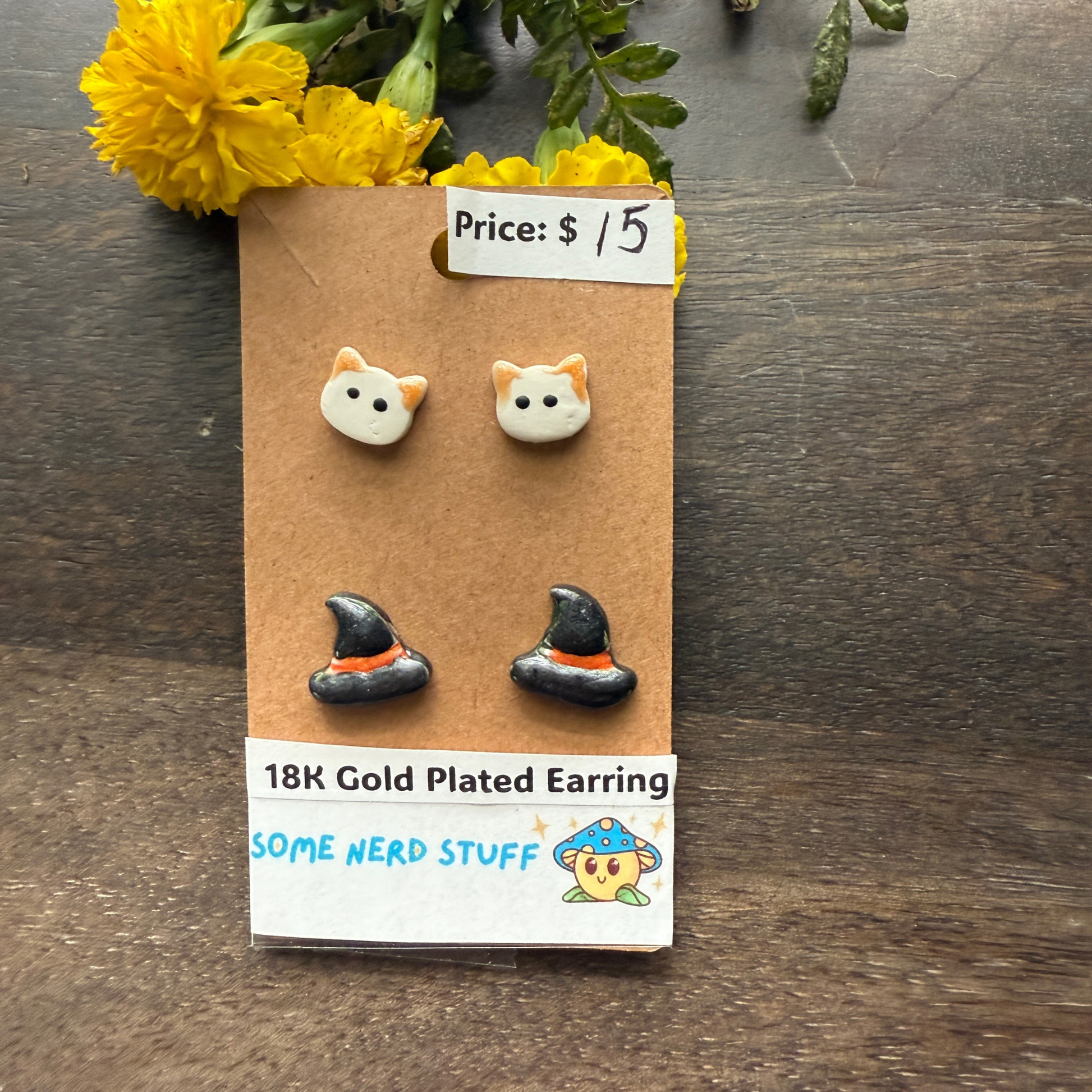 Halloween Cat and Witch hat studs that are 18k plated sold by SomeNerdStuff