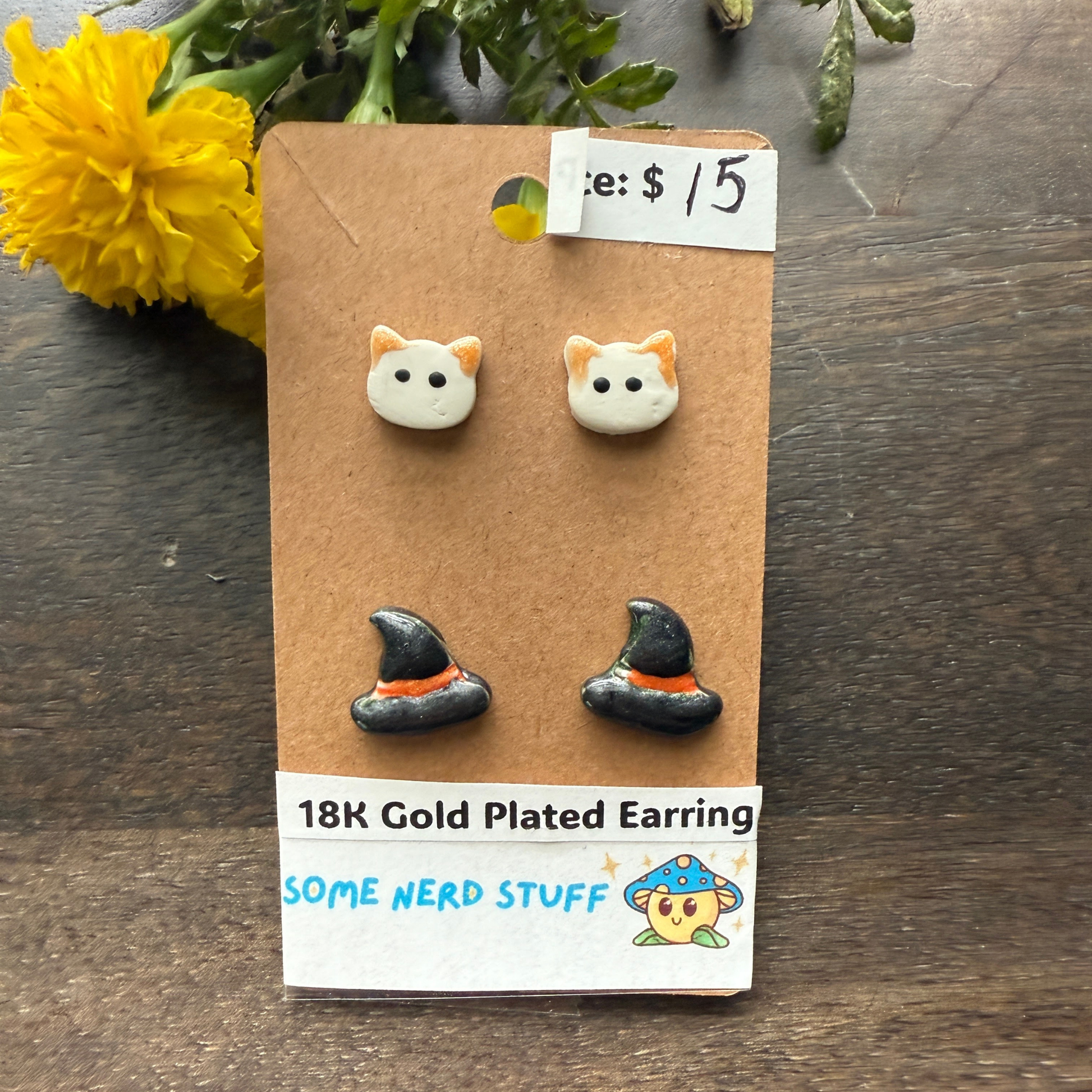 Halloween Cat and Witch hat studs that are 18k plated sold by SomeNerdStuff