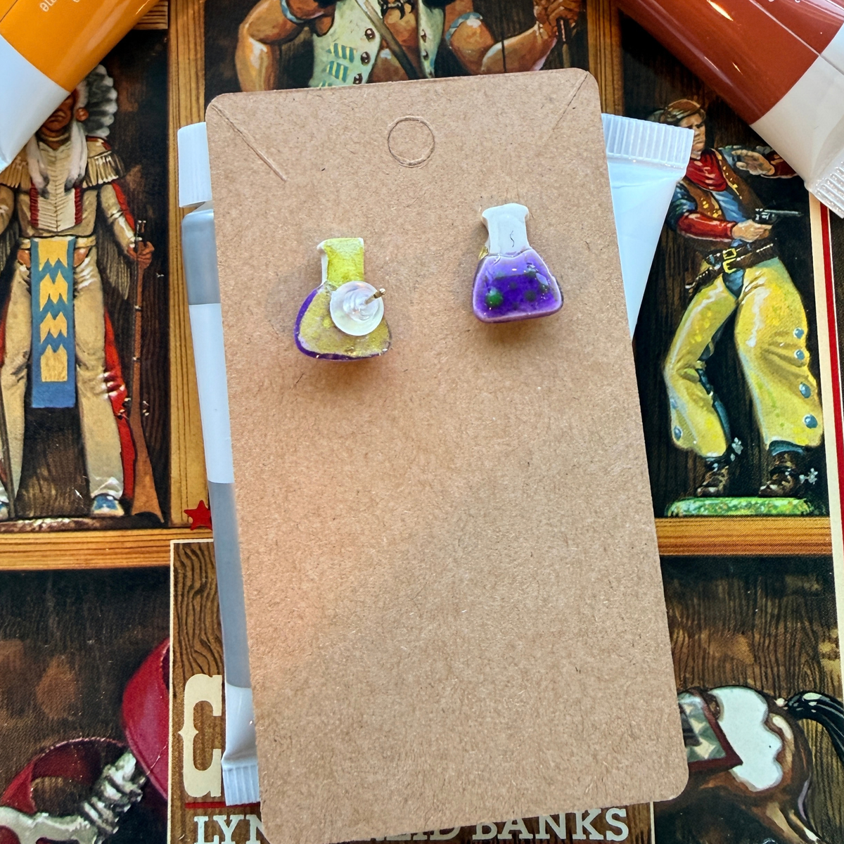 Front and back of purple beaker stud earrings, showing the post and backing.