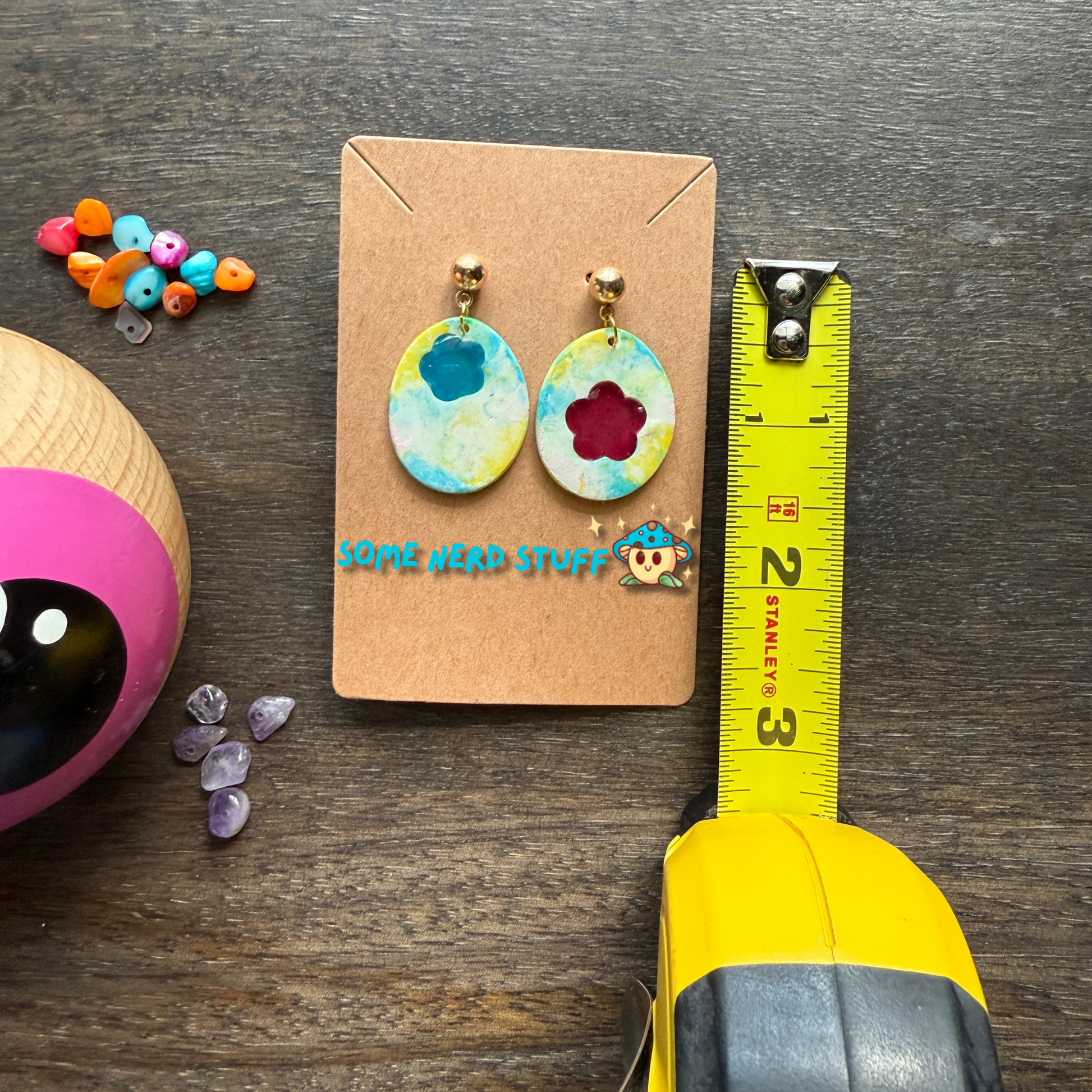 Polymer clay Love by you song Steven Universe inspired jewlery earrings shown with measuring tape made by SomeNerdStuff