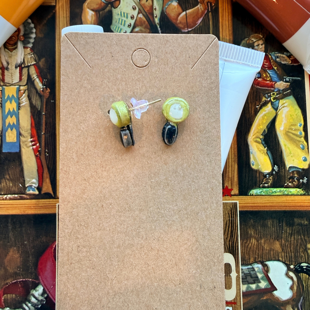 Front and back of magnifying glass stud earrings, showing the post and backing.