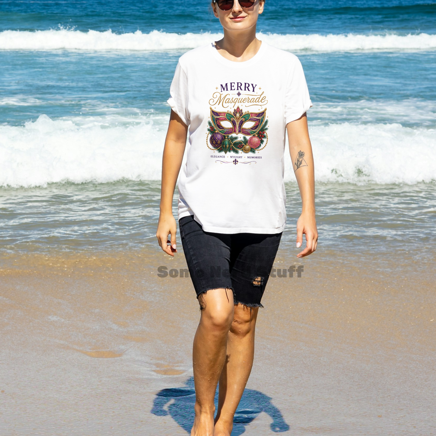 Woman wearing the Merry Masquerade Christmas Cruise Shirt while walking on the beach in a festive holiday cruise shirt.