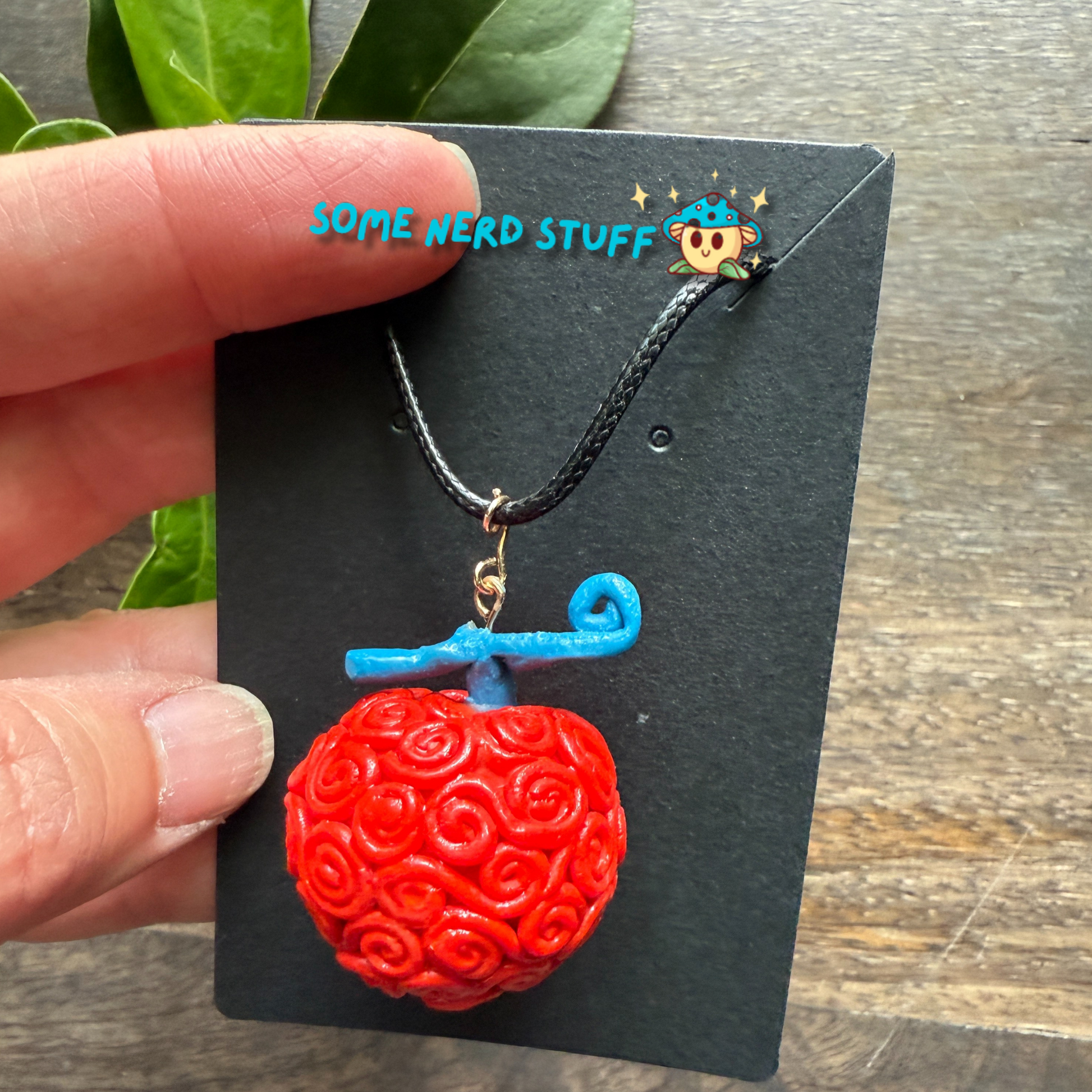 Ope Ope no Mi Necklace charm showing size compared to hand of necklace made by SomeNerdStuff