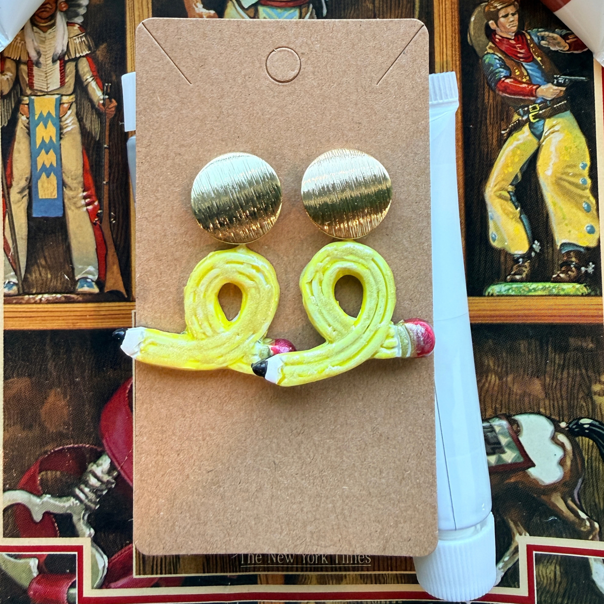 Looped yellow pencil dangle earrings with red eraser details and round gold-tone stud tops.