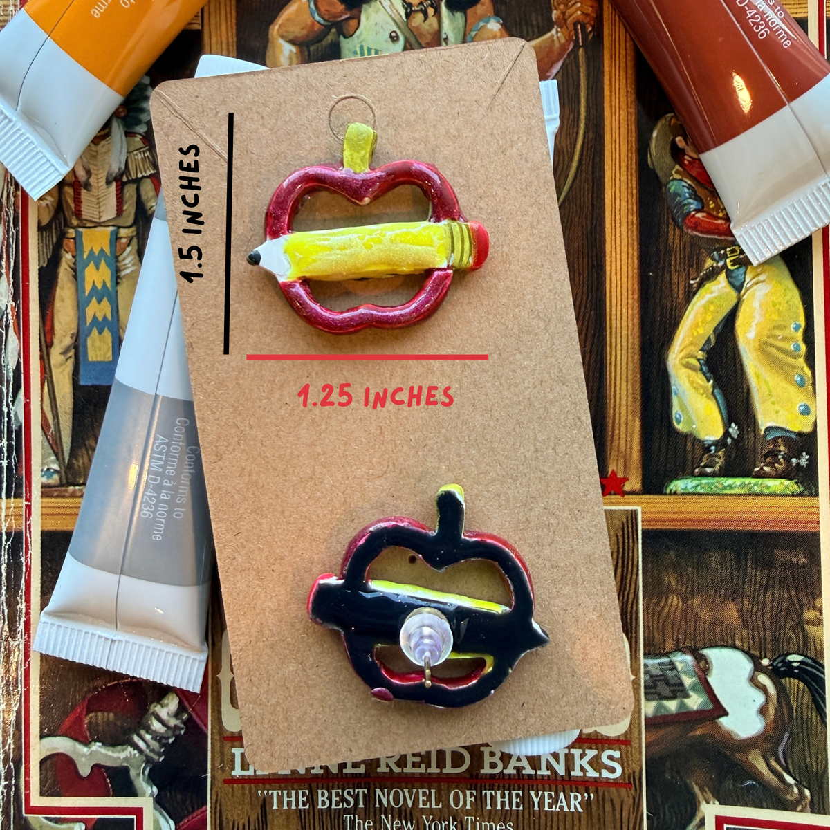 Front and back of an apple and pencil stud earring, with dimensions marked 1.5 inches high by 1.25 inches wide.