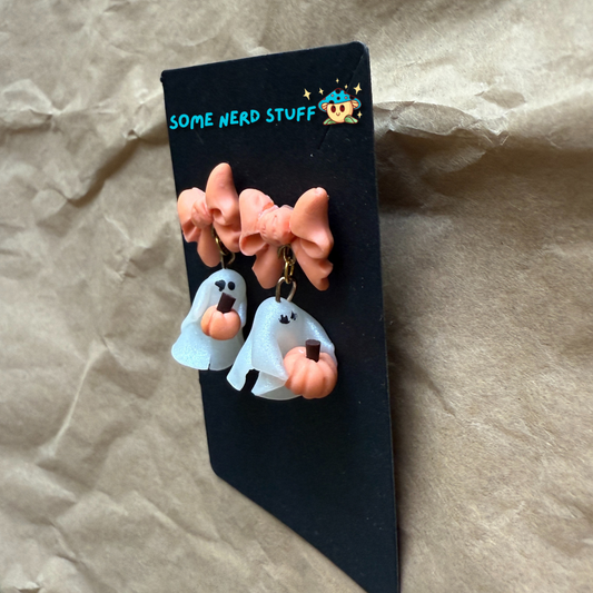 Polymer Clay Stud earrings with peach bows, phantoms holding pumpkins side view made by SomeNerdStuff